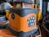 an orange and black machine sitting on top of a wooden table