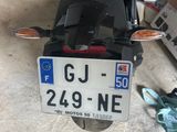 a motorcycle parked in a garage with a license plate attached to it