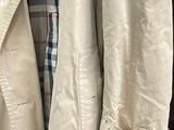 two jackets hanging on a rack in a store