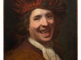 portrait of a laughing man in a red hat by person