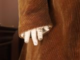 a close up of a person ' s hand with a glove on