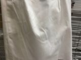 a white skirt hanging on a rack in a store