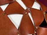 a close up of a mannequin wearing a brown and white dress