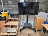 a television on a stand in the middle of a room