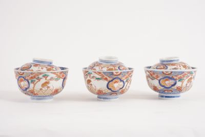 three small vases sitting on top of a white surface next to each other
