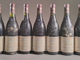 six bottles of wine are lined up in a row on a table
