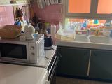 a kitchen with a sink, stove, and microwave in it