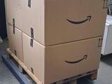 two boxes on a pallet with a smile drawn on them