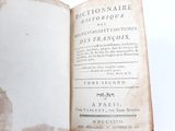 an old book opened on a table with a white background
