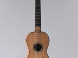 an acoustic guitar hanging from the ceiling