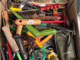 a cardboard box full of gardening tools on a table
