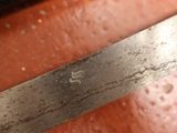 a close up of a knife on a cutting board