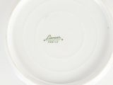 a white plate with a green inscription on it