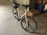a bike that is parked in a garage next to a box