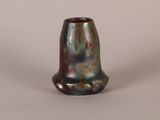 a close up of a vase on a white surface