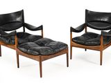pair of black leather lounge chairs and ottoman with wooden legs