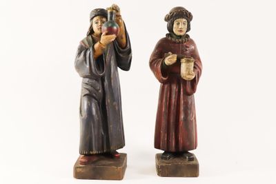 pair of wooden figurines of two people holding cups of coffee