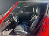 a picture of a red car with black seats and a steering wheel