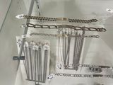 a glass display case with a lot of silver jewelry on it