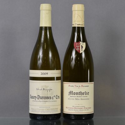 two bottles of wine sitting on top of a table next to each other