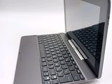 a silver laptop with a black keyboard on a white surface