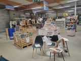 many chairs and tables in a store with a lot of books