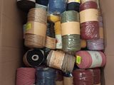 a box full of different colored yarns in it