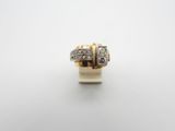 a gold and diamond ring on a white surface