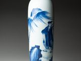 a blue and white vase with a bird on it