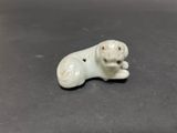 an image of a small figurine of a dog on a table