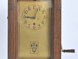 a wooden clock that is sitting on a white surface