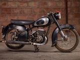 a motorcycle that is parked in front of a brick wall