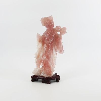 a figurine of a woman standing on a wooden base