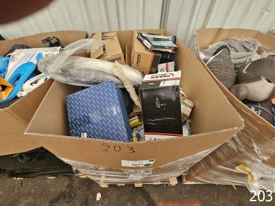 a cardboard box filled with assorted items on the ground