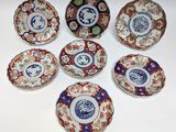six plates with different designs on them sitting on a white surface