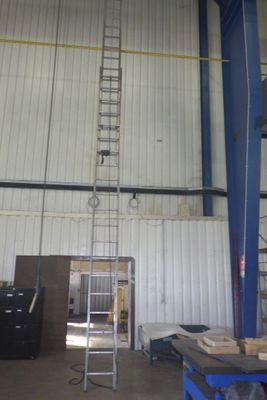 a ladder in a building that is being used to climb a ladder