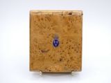 an image of a small wooden box with a blue emblem on it