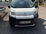 a small white van parked on the side of the road