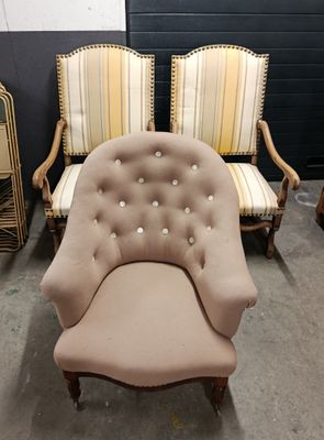 two chairs and a chair that are sitting in a room