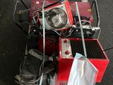 a red machine that is sitting on a pallet