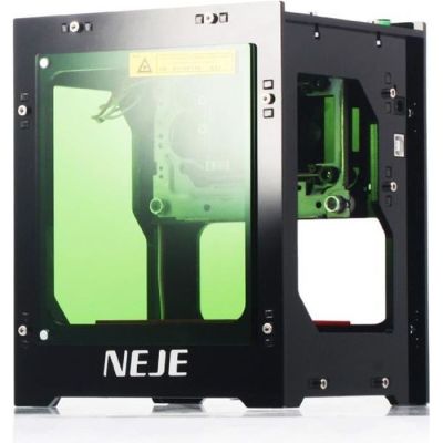 the 3d printer is sitting on a white surface with a green screen