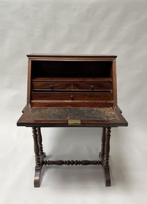 an old wooden desk with a drawer on top of it