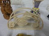 a table with a basket, vase, and other items on it