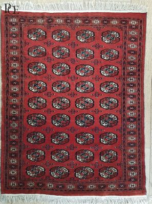 a red rug with a pattern on it