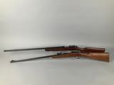 a rifle with two rifles on a white background