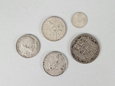 four different types of coins are shown on a white surface
