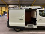 a white van parked in a parking lot with its doors open