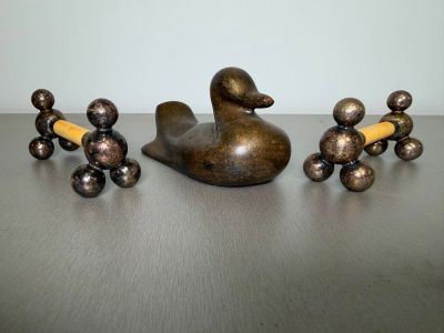 a statue of a duck and a group of candlesticks on a table