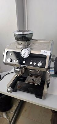 a coffee machine sitting on a table with a bowl on it