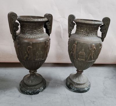 two vases that are sitting next to each other on the floor